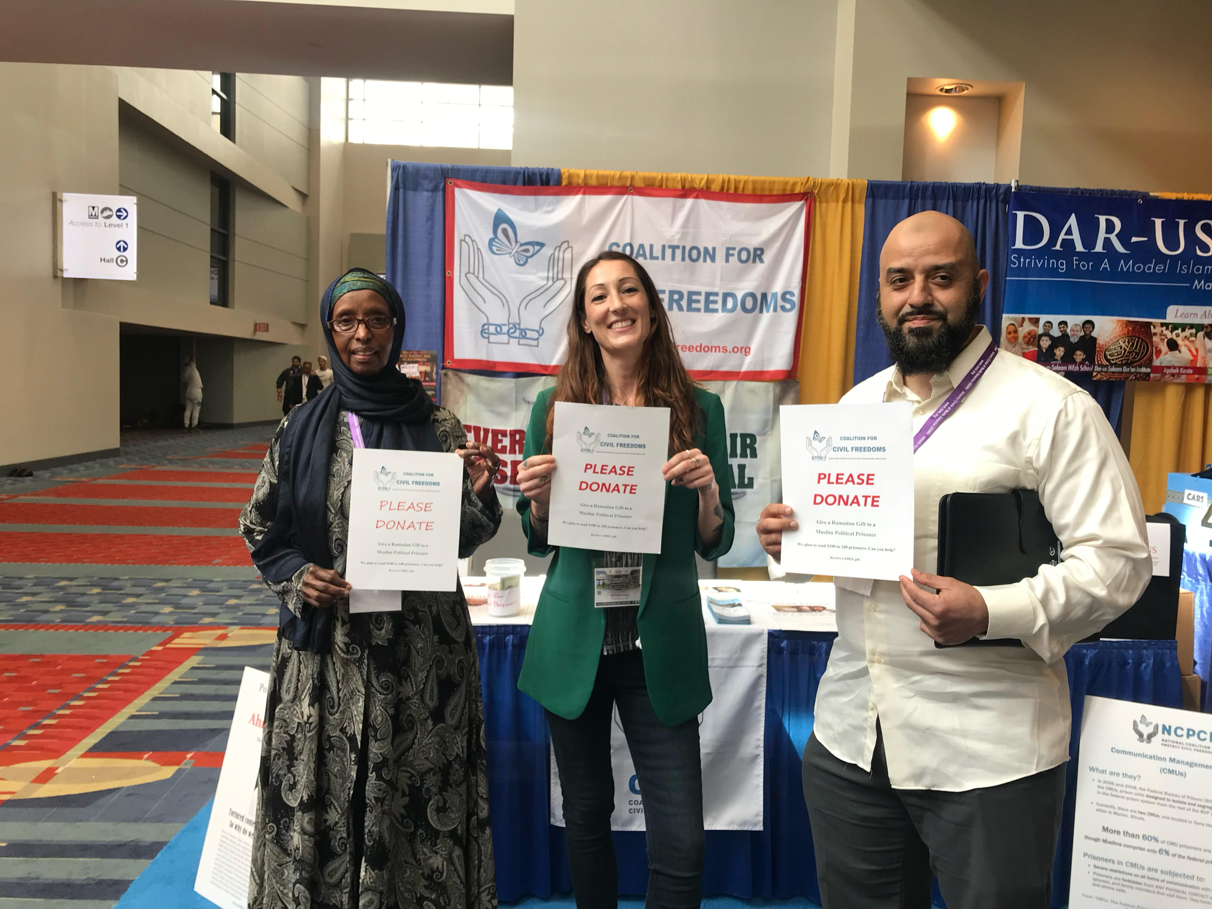 Three people holding a paper that reads 'Please Donate'